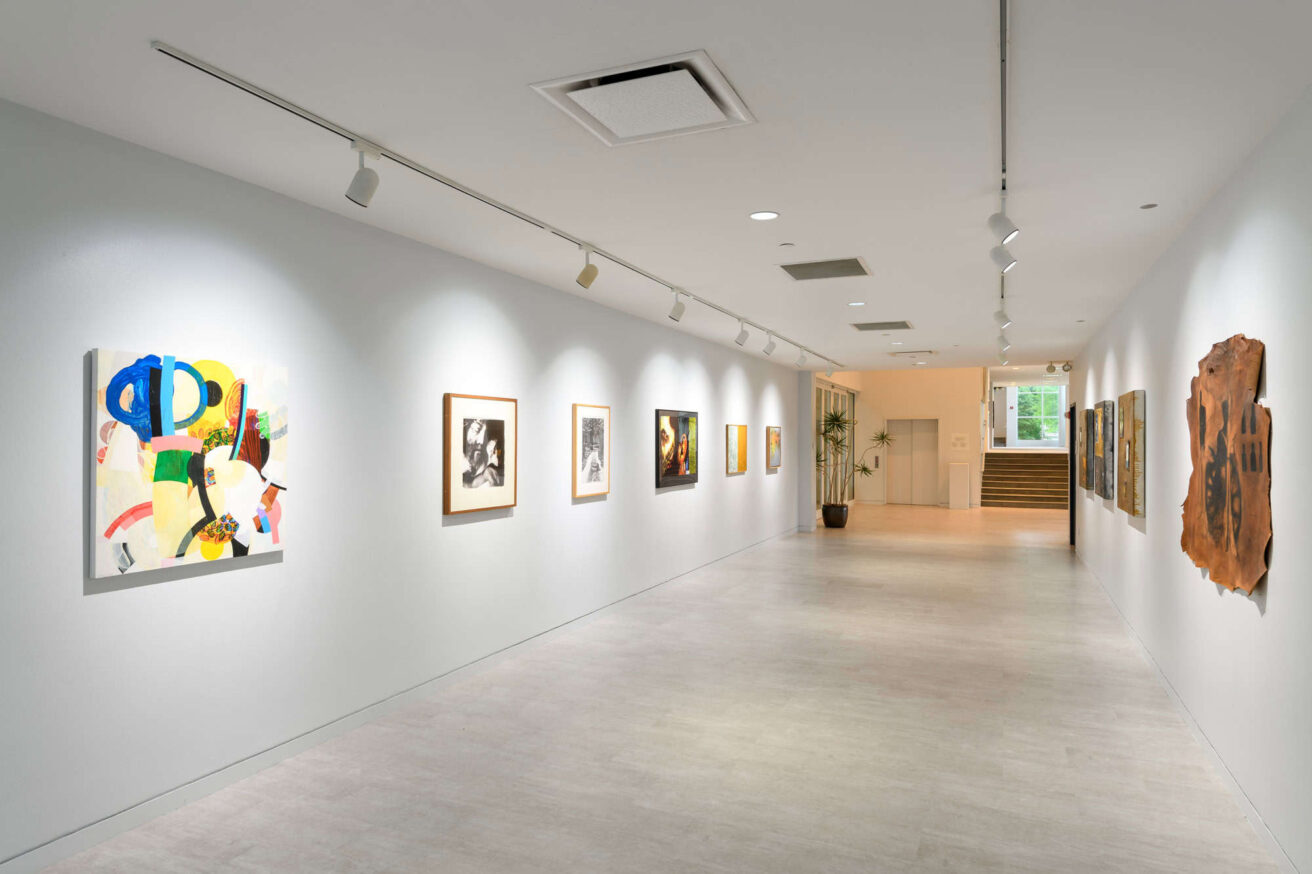 An art gallery with paintings hanging on the wall.