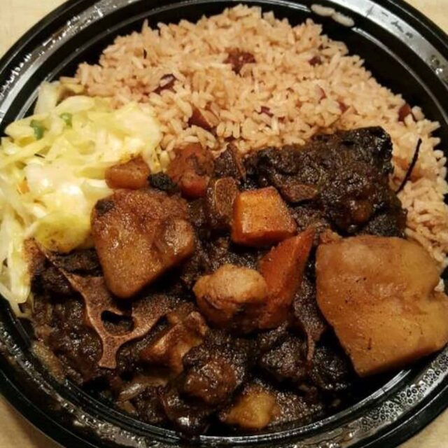 A bowl of food with rice and meat in it.