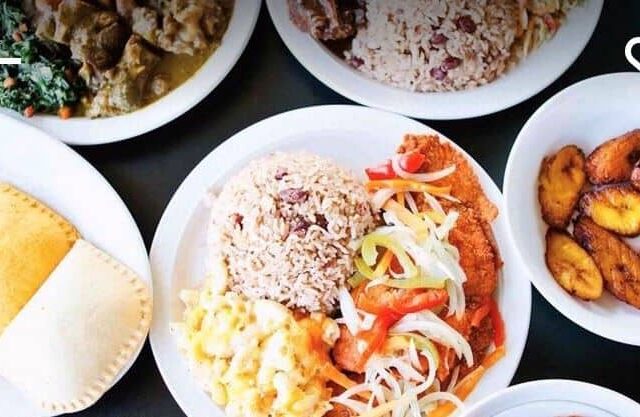 A plate of food with rice, beans, and other foods.