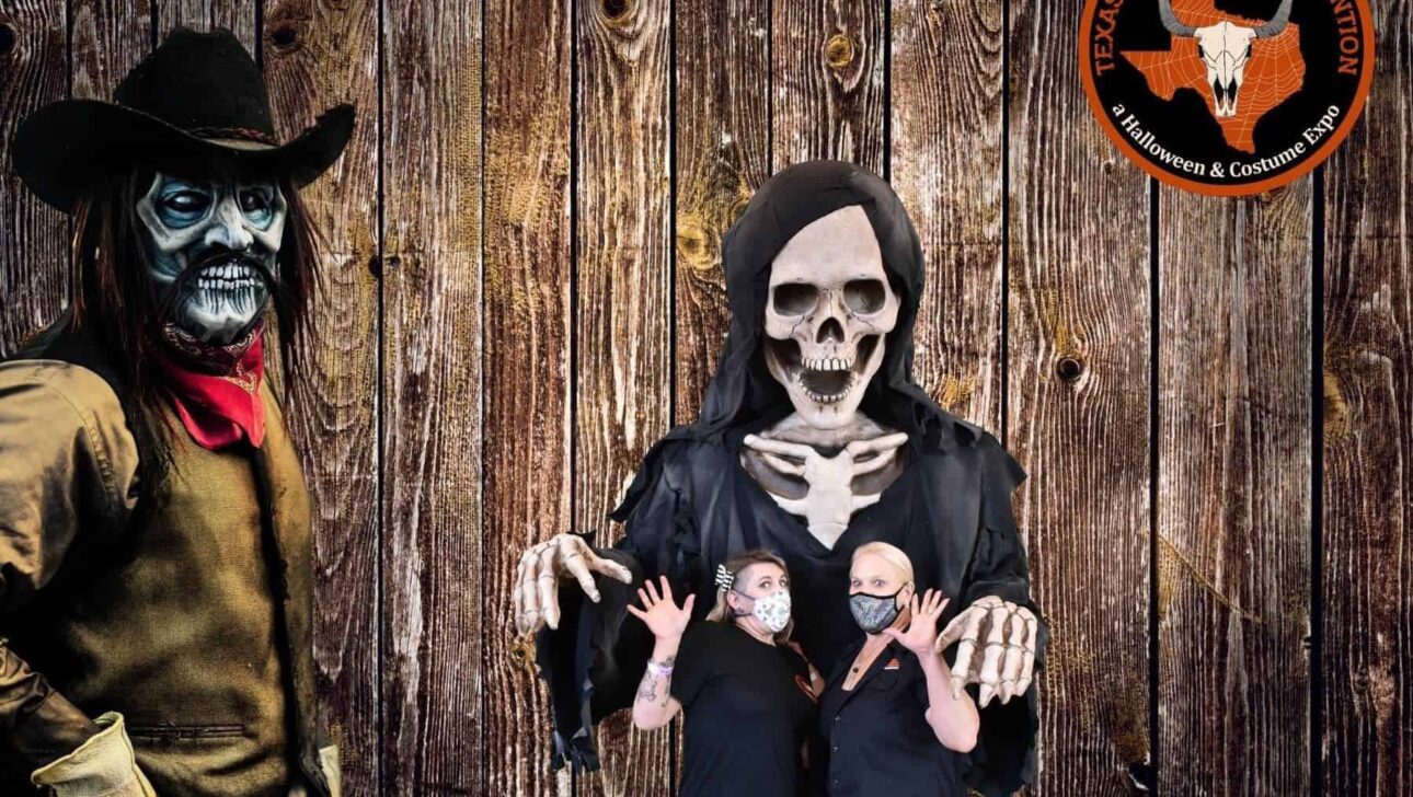 Four individuals dressed in halloween costumes for a spooky photo opportunity against a wooden backdrop.