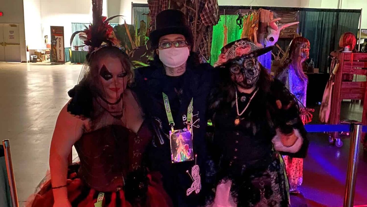 Four individuals in elaborate costumes posing together at an event.